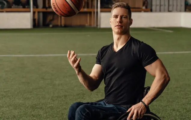 Man Sitting on Wheelchair while Playing with the Ball