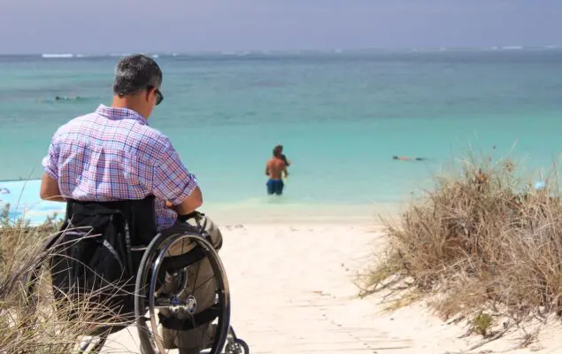 woman riding wheelchair near trees